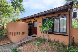 a house with a front door and a window at San Lameer Villa 2027 - 2 Bedroom Superior - 4 pax - San Lameer Rental Agency in Southbroom
