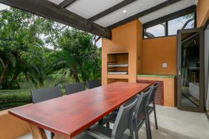 a wooden table and chairs on a patio at San Lameer Villa 2027 - 2 Bedroom Superior - 4 pax - San Lameer Rental Agency in Southbroom