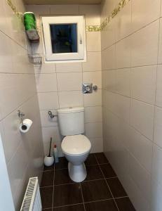a small bathroom with a toilet and a window at Obuda flat in Budapest