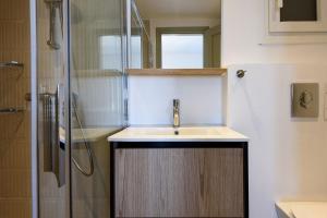 a bathroom with a sink and a shower at Phaedrus Living Paros Cycladic Residences 3 in Kampos Paros +3 photos