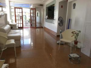 a living room with a couch and a table and chairs at House of Big Brother in Puerto Princesa City