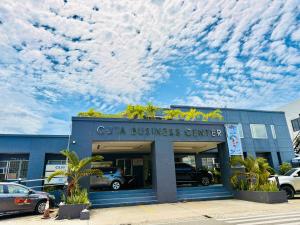 a car business center with clouds in the sky at Casa Ysabel Transient Inn in Ayusan Norte