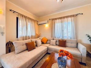 a living room with a couch and a table at Villa Hestia - Seaview Serenity Villa with Private Pool by Villa Mana Gers in Kypseli