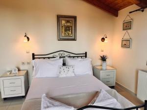 a bedroom with a large bed with white pillows at Villa Hestia - Seaview Serenity Villa with Private Pool by Villa Mana Gers in Kypseli