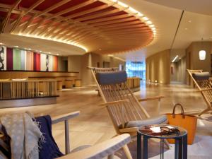 a lobby with chairs and tables in a building at Mitsui Garden Hotel Kyoto Shijo in Kyoto