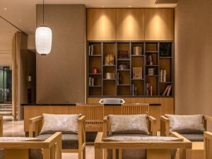 a waiting room with chairs and a book shelf at Mitsui Garden Hotel Kyoto Shijo in Kyoto