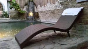 a bench sitting in front of a fountain at Simons Heritage Resort Puerto Galera in Puerto Galera