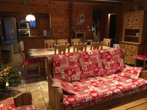 a living room with a couch covered in christmas pillows at Chalet de la Roche Gauthier in Gérardmer