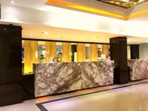 a lobby with a marble counter in a building at Grand Hawaii Hotel Pekanbaru in Pekanbaru