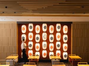 a person standing in front of a wall in a classroom at Mitsui Garden Hotel Kyoto Shijo in Kyoto