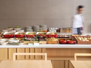 a buffet with bowls of food on a table at Mitsui Garden Hotel Kyoto Shijo in Kyoto