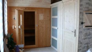 a room with a wooden closet with a door at Chalet de la Roche Gauthier in Gérardmer