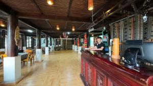 a man sitting at a bar in a restaurant at Handspan Homestay Sapa in Sa Pa +32 photos