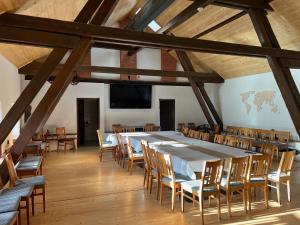 a large room with a long table and chairs at Feltlův mlýn v Borovnici in Borovnice