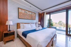 Postel nebo postele na pokoji v ubytování Puri Pandawa Resort