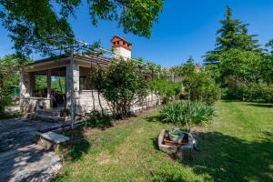 a house with a tower on top of a yard at Villa Mediterranea, an idyllic new villa with a Mediterranean touch in Vinež