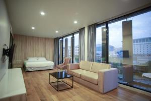 a living room with a couch and a bed at Holiday Poipet in Krong Poi Pet +128 photos