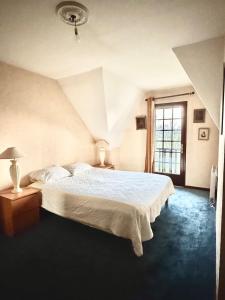 La Celle-sous-GouzonにあるVilla Verde Normandyの白いベッドと窓のある寝室