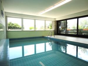 a swimming pool in a house with a large window at Ferienwohnung Seeblick Aigner in Seeboden