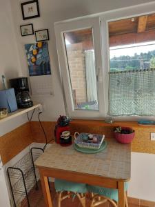 a small kitchen with a table and a window at Apartman Karo in Vrsar