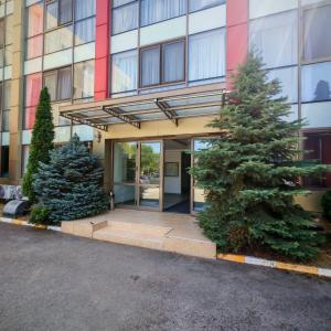 a building with a christmas tree in front of it at My-RIN in Otopeni