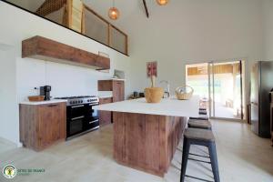a kitchen with wooden cabinets and a white counter top at Cottage RG in Lamothe-Landerron