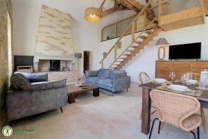 a living room with a couch and a table at Cottage RG in Lamothe-Landerron