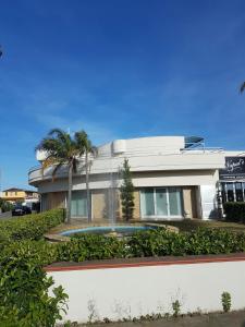 a house with a swimming pool in front of it at Santa Lucia Hotel in Corigliano Calabro