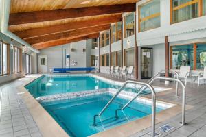 a swimming pool in a building with a large building at Best Western River Terrace in Cheboygan
