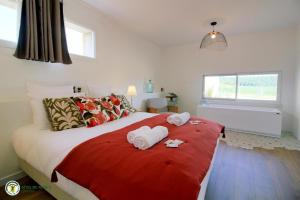 a bedroom with a large bed with towels on it at Cottage RG in Lamothe-Landerron +19 photos