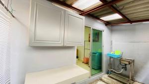 a bathroom with white cabinets and a shower at Cozy 3 Bedroom Townhouse Phuket Town - Sleeps 7 in Ban Khok Chang +12 photos