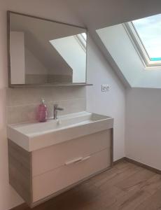 a bathroom with a sink and a mirror at Chambres d'hôtes au cœur de la Mayenne in Saint-Mars-du-Désert