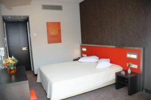 Postel nebo postele na pokoji v ubytování Hotel Des Roses