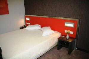 Postel nebo postele na pokoji v ubytování Hotel Des Roses