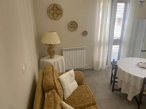 a living room with a chair and a table at 4 Seasons in Altavilla Milicia