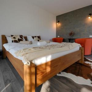 a bedroom with a large wooden bed with orange chairs at LakeView Villas 
