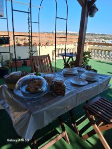 a table with a plate of food on it at Villa Zammitella in St. Paul's Bay