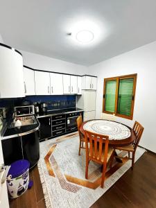 a kitchen with a table and chairs in a room at OLIVE Home in Durrës +21 photos