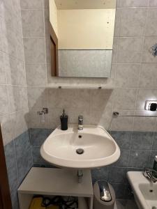 a bathroom with a sink and a mirror at Appartamento vista mare in Grottammare