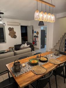 a living room with a wooden table with food on it at Cretan Odyssey Maisonette in Maleme