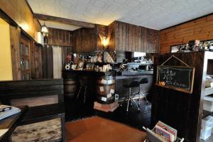 a kitchen with a bar in a room with wooden walls at Secret Base Tokinokakera in Yufuin