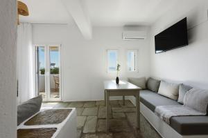 a living room with a couch and a table at Phaedrus Living Paros Cycladic Residences 6 in Kampos Paros