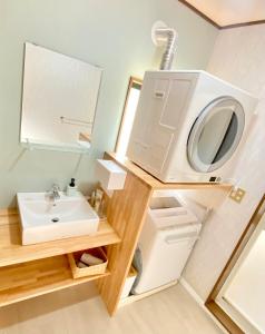 a bathroom with a sink and a washing machine at Family Home Walking to the Beach Park & Playground in Hasunuma +39 photos