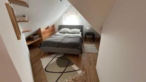 a bedroom with a bed in a attic at Apartament Zamoście in Zamość