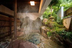 a hot spring in the middle of a garden at 【Newly Opened】Yufuin Geihinkan Kura in Yufuin