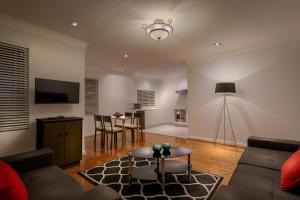a living room with a couch and a table at Crest On Barkly Serviced Apartments in Melbourne