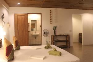a room with a bed with a sink and a mirror at Chindonan Dive Resort in Coron