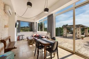 a living room with a table and chairs at Biancaluna Luxury Retreat by Perle di Puglia in Ostuni