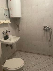 a bathroom with a toilet and a sink at KudevApartment1 in Nesebar +13 photos