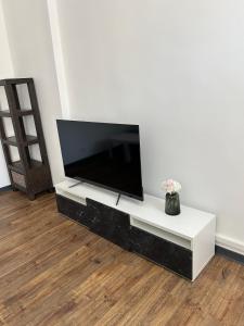a living room with a flat screen tv on a white wall at Le Rouet in Marseille